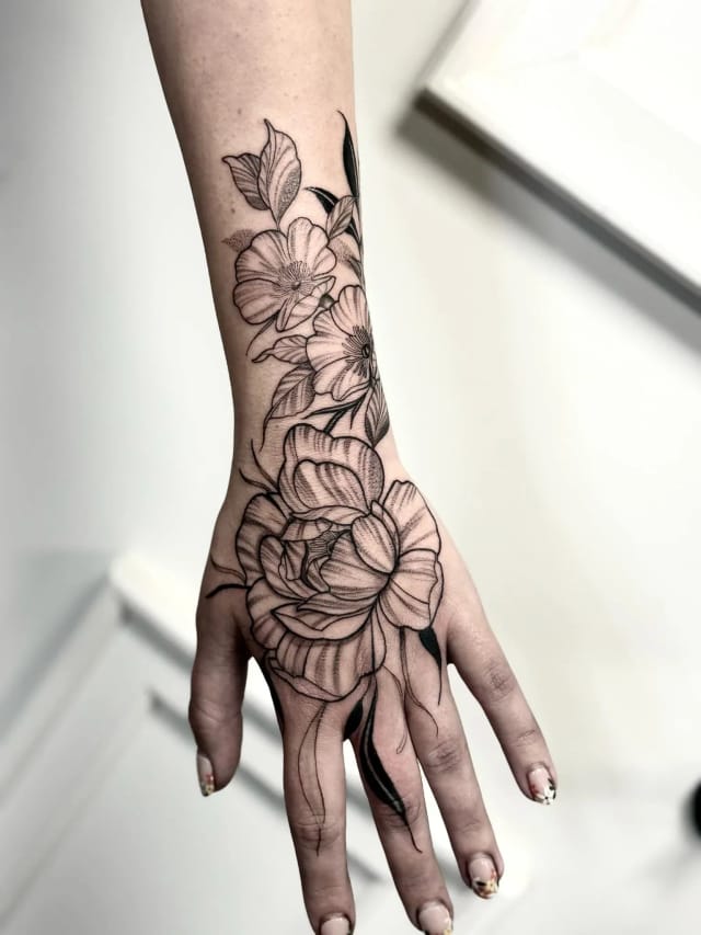 Fine line floral hand tattoo by Amour Tattoo, Hull tattoo artist